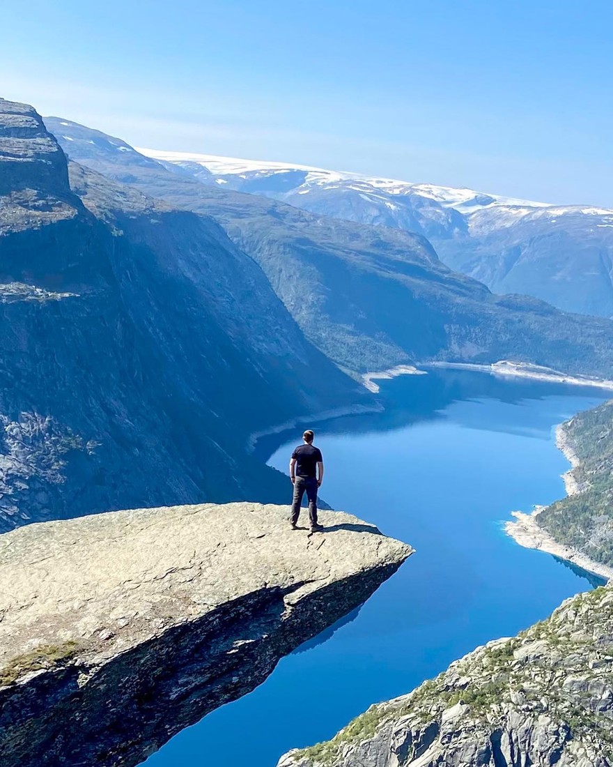 Neil standing on the Trolltunga cliff ledge above a Norwegian fjord
